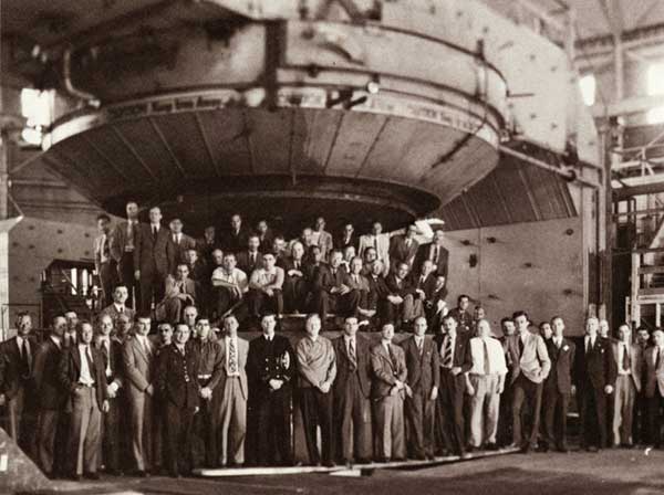 Lawrence and staff posing with the magnet of the 184-inch synchrocyclotron