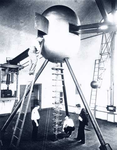 Van de Graaff generator being worked on by scientists.